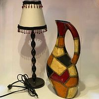 Photo showing the full view of the beaded table lamp alongside the large ceramic Art Deco pitcher with multicolor patchwork design.