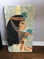 Front view showing Cleopatra profile and vibrant paint on plaster