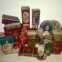 Wide view of collection showing various vintage tins with different shapes and designs.