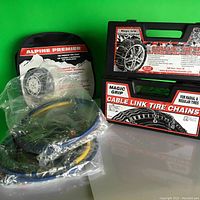 Full view of the tire chains in original packaging including Magic Grip box and Alpine Premier instructions.