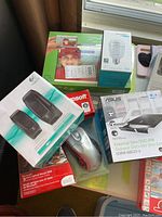 Photo showing all items in lot including Logitech speakers, Asus DVD drive, Microsoft mouse, Kurzweil software, Epson software, and Sengled LED Wi-Fi bulb.