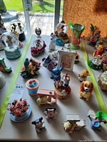 Overview of the Disney figurines and Precious Moments frame arranged on a table, showing the variety and scale of the items