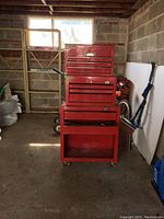 Full view of three red Jobmate tool chests stacked in garage