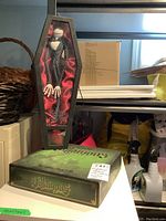 Jack Skellington doll boxed in coffin-shaped case with red interior fabric, labeled The Nightmare Before Christmas