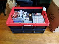 Red CleverMade crate filled with stacks of PS3 game cases