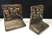 Two solid brass bookends showing detailed wildlife relief of deer and a fawn surrounded by foliage.