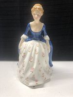 Front view of Royal Doulton Alison HN2336 porcelain figurine showcasing detailed facial features and floral decorated skirt.