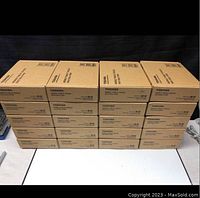 Stack of 20 cardboard boxes containing Toshiba Mobile Tablet Cradles shown from front in rows of five by four.