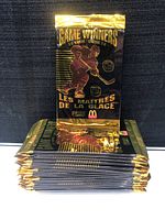 Stack of 15 unopened black and gold 3D Game Winners hockey trading card packs.