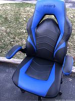 Front view of BYERGE black and blue computer chair showcasing cushioned seat and backrest with armrests.