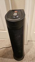 Front and side view of the black Hoover air purifier, showing tower design.