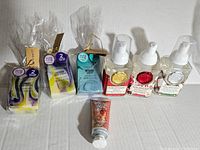 Photo of assorted handmade soap bars and foaming hand soaps with lotions, plus a small tube of hand cream.