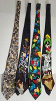 Four neckties laid out flat showing various cartoon character designs from Disney and Warner Bros.