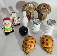 Full lot of vintage salt and pepper shakers in novelty and collectible designs, including holiday and animal themes.