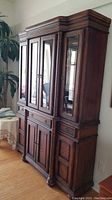 Full view of wood carved basket weave china cabinet showing overall design, drawers, doors, and side profile.