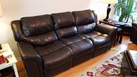 Angled front-left view of the full couch showing overall condition and leather surface