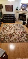 Rug placed in a living room setting showing floral pattern and overall size.