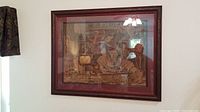 View of the framed tapestry hung on the wall, showing the whole artwork and frame.
