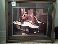 Full view of the framed print showing two women at a dinner table with candles.
