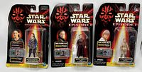Photo of three unopened Star Wars Episode 1 action figures from 1998, showing front packaging with character art and CommTech Chips clearly visible.