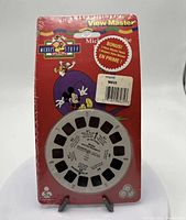 Red blister pack with View-Master reels labeled Mickey Tuff. Front shows one reel visible and packaging sealed, sticker price $4.99.