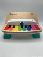 Front view of the Baby Einstein Hape piano keyboard toy showing colorful keys and white control panel.