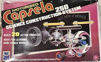 Front of the Capsela 250 box showing colorful science construction model with motor and propeller, highlighting 20 action projects and educational STEM learning