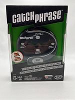 Front view of the Catch Phrase electronic game in original sealed packaging showing the game device and brand information.