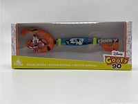 Front view of Disney Special Edition Goofy 90 decorative collectible key inside original packaging. Orange and blue with Goofy character design.