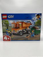 Front view of the LEGO City 60220 garbage truck building set box, showing the truck, minifigures, and piece count.