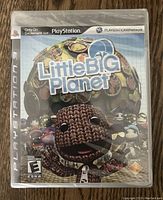 Front cover of the LittleBigPlanet PlayStation 3 game sealed in original plastic wrap.