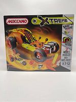 Front view of the sealed Meccano Extreme building set box showing the orange car model and highlighting 80+ parts with pull-back motor.