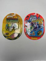Front view of two unopened Might Beanz packs, one with Teenage Mutant Ninja Turtles theme and one with Beanz Bodz theme