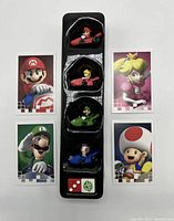 Four Monopoly Gamer Mario Kart character pieces in tray with five corresponding character cards around them.