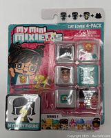Front view of sealed My Mini MixieQ’s Cat Lover 4-Pack Series 1 blister card showing 2 figures, 1 mystery figure silhouette, 1 cat pet, and extra accessories inside clear plastic compartments.