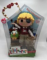 Front view of the Lalaloopsy Patch Treasurechest doll in original packaging showing doll, green plush accessory, and pirate-themed box.