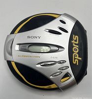 Top view of Sony Sports Walkman D-SJ15 showing yellow and black casing with silver button controls and digital display.