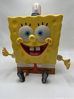 Front view showing SpongeBob's facial features, body, arms, legs, and top hat lid with anchor emblem
