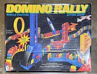 Box showing Domino Rally Action Alley vintage 1994 game with colorful graphics of a domino course including loops and action features