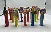 Photo showing full lot of 11 vintage PEZ dispensers with various character heads and colors
