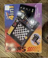 Packaging box for the Saitek electronic 4 in 1 game with colorful graphics and product details.