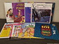 Set of 9 vintage cartoon and Disney vinyl record albums in varied condition with cover artwork.