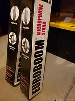 Two Euroboom microphone stands in original packaging, showing product name and brand.