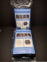 Two brand new dog seat covers in original packaging, showing front and back of packaging with product details.
