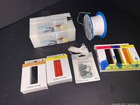 Overview of all candle making supplies including wax blocks, wick spool, dye chips, wick tabs, and match holders.