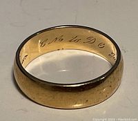 Ring positioned to show overall shape and interior inscription