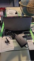 Bose SoundDock Series II speaker dock with power adapter and instruction manual.