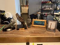 All items displayed on table showing figurines and frames from left to right
