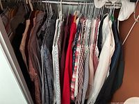 Full rack view of shirts and jackets on hangers