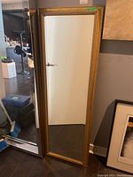 Front view of the full mirror showing reflective surface and frame